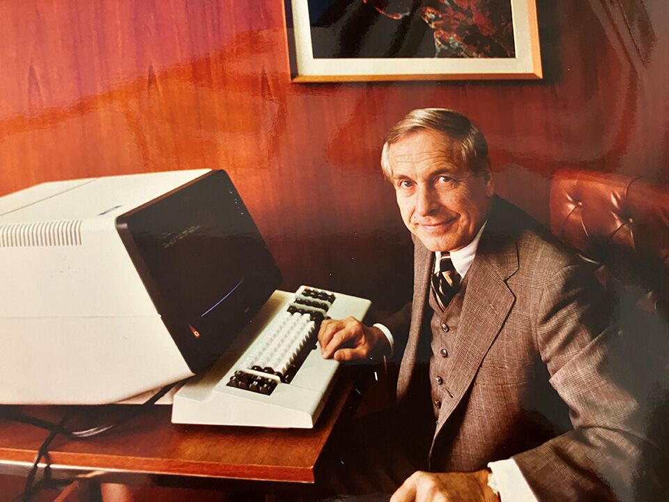 Russell Bliese working in front of an early model IMB computer