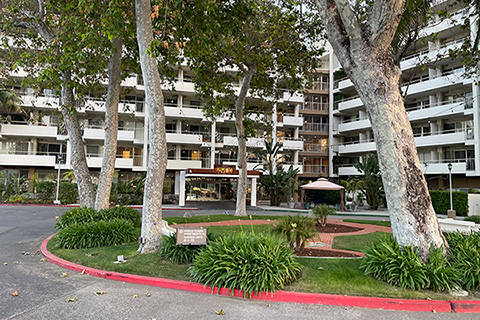 Ventura Townehouse front entrance circular driveway with trees in a grassy center round park area