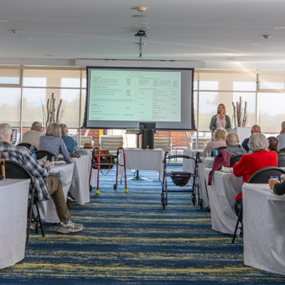 A room full of senior attendees listen to speaker Amanda Ralstin and our Empowered Living Senior Seminar